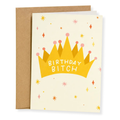 A birthday card with a kraft envelope, featuring a yellow crown illustration with the text 'BIRTHDAY BITCH' on a cream background with small colorful star and diamond accents.