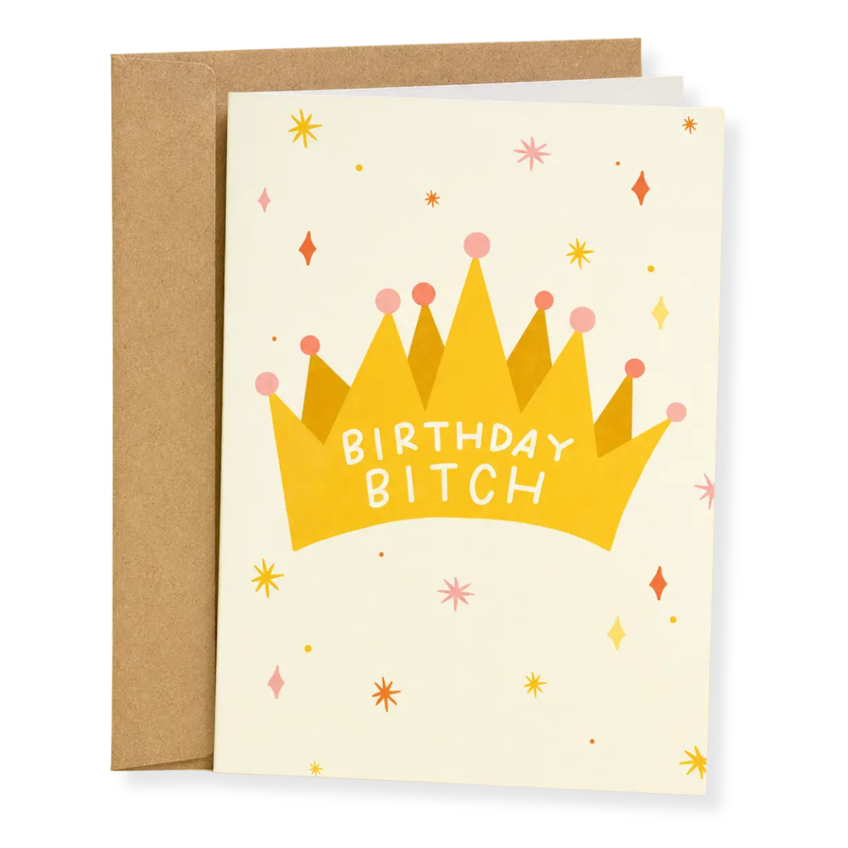 A birthday card with a kraft envelope, featuring a yellow crown illustration with the text 'BIRTHDAY BITCH' on a cream background with small colorful star and diamond accents.