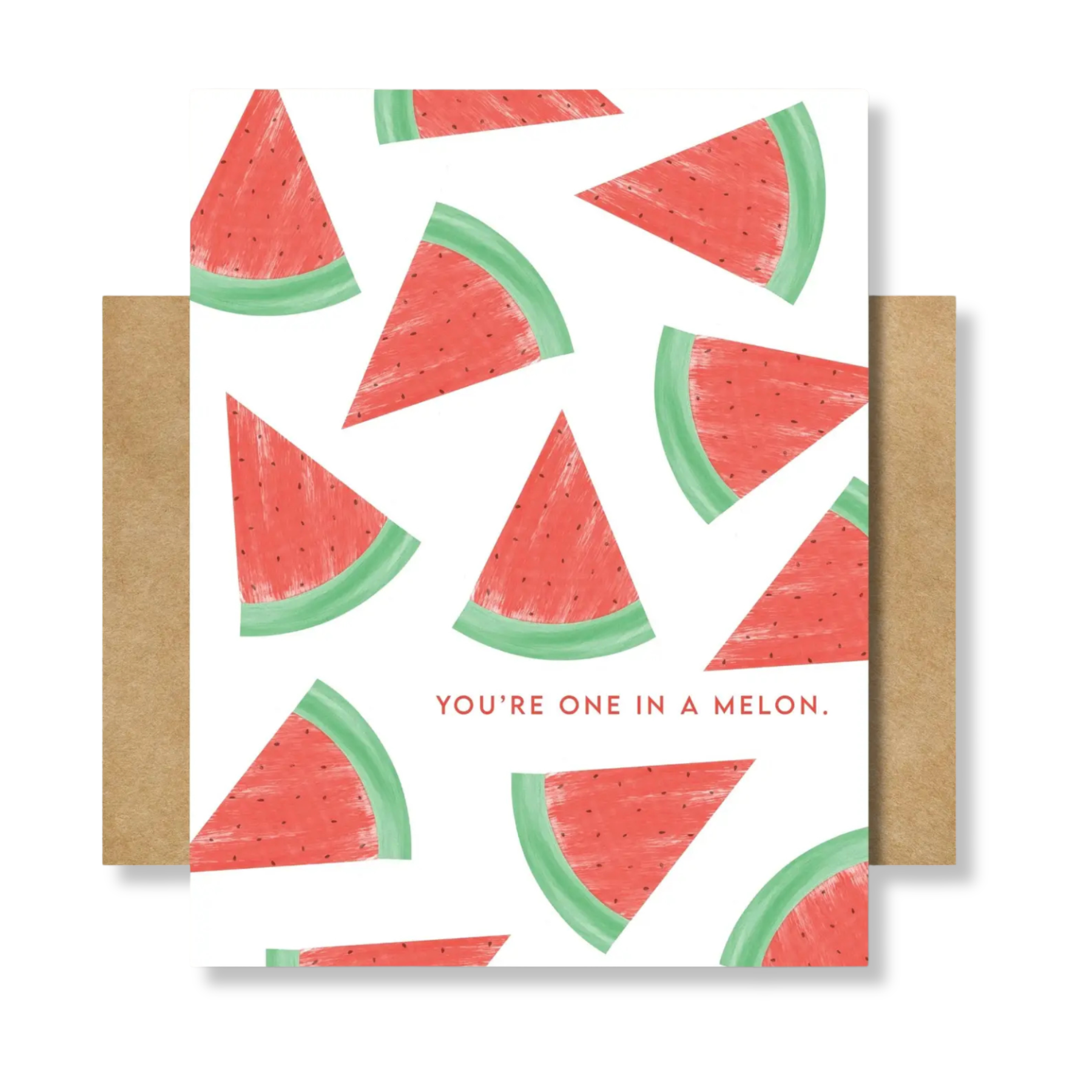 A watermelon-patterned greeting card with red watermelon slices on a white background and the phrase 'YOU'RE ONE IN A MELON.' printed near the bottom, shown with kraft paper envelopes on both sides against a light gray background.
