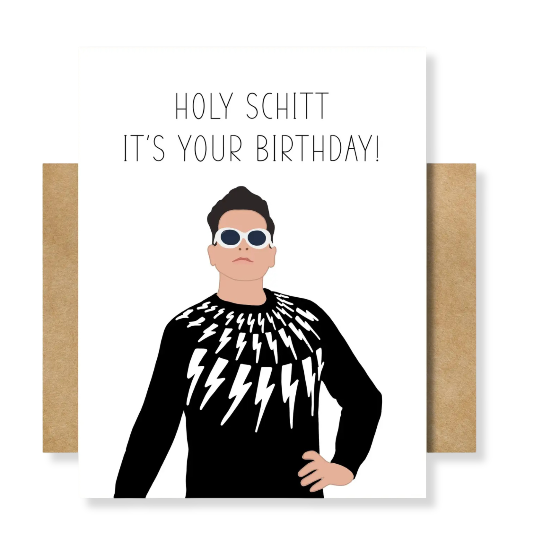 A greeting card with a white front featuring the text 'HOLY SCHITT IT'S YOUR BIRTHDAY!' above an illustrated man in a black sweater with white lightning-bolt patterns, shown with brown kraft envelopes on both sides against a white background.