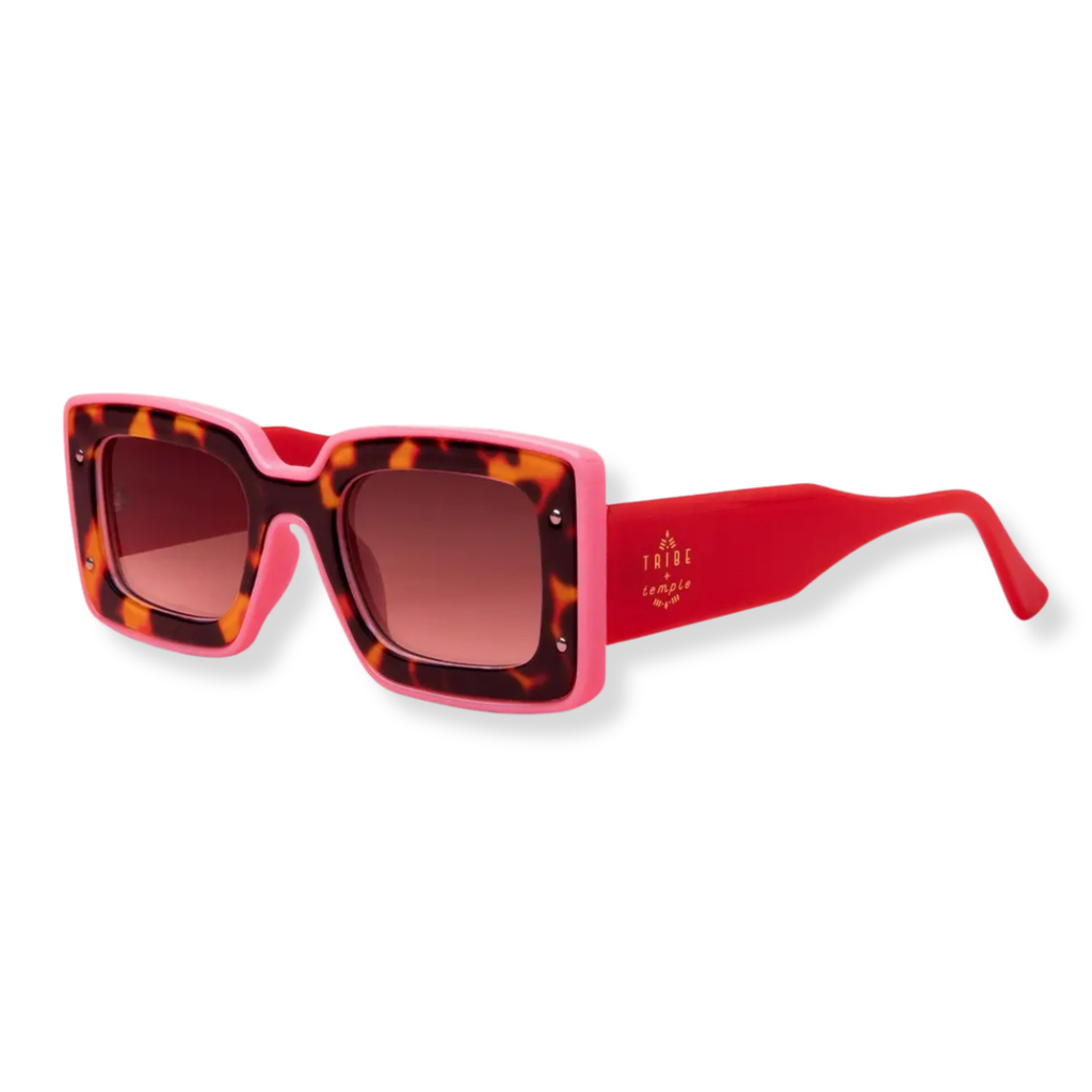 TRIGR square sunglasses with a pink acetate frame, tortoiseshell-patterned front rims, and bright red temples with gold brand lettering, shown on a white background.