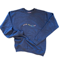 A heathered blue crewneck sweatshirt with 'NEW ORLEANS' printed in multicolored letters across the chest, laid flat on a white background.