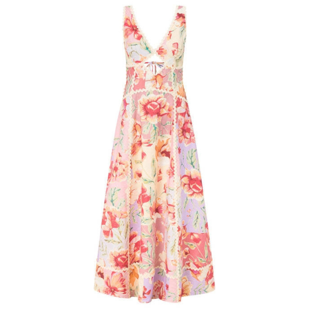 A sleeveless V-neck maxi dress with a colorful floral patchwork print in shades of pink, red, orange, and green on a light cream background, featuring a tie detail at the waist.