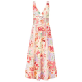 A sleeveless V-neck maxi dress with a colorful floral patchwork print in shades of pink, red, orange, and green on a light cream background, featuring a tie detail at the waist.