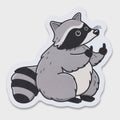 A die-cut sticker featuring a cartoon raccoon in gray, black, and white, shown on a light gray background.