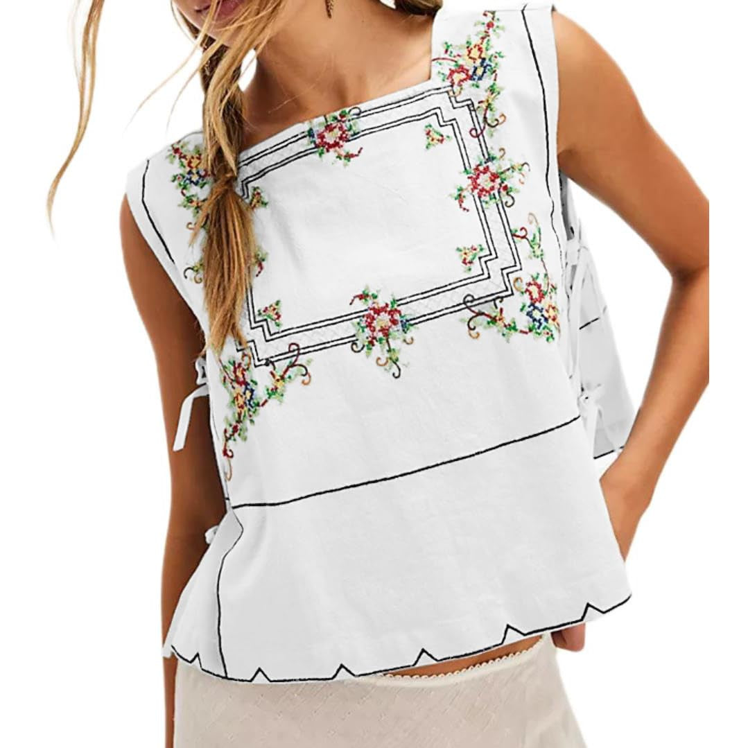 White sleeveless top with floral embroidery on a white background