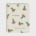 Card with duck illustrations and text on a beige background
