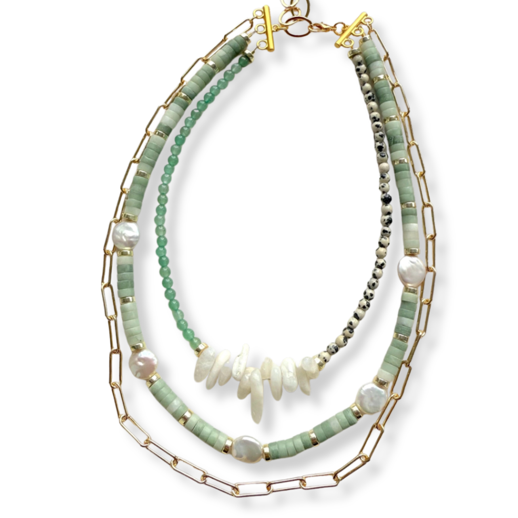 A multi-strand necklace featuring light green beads, white baroque pearls, raw shell fragments, and gold-tone chain and link details, displayed on a clean white background.