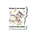 A die-cut sticker featuring a cartoon gray tabby kitten holding a flower bouquet, with the text 'Therapy is not enough' above and 'I need to bite people' below, on a white background.